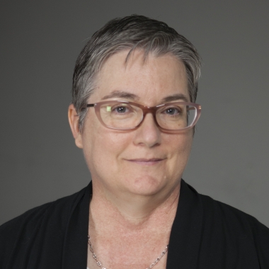 Woman with short hair and glasses