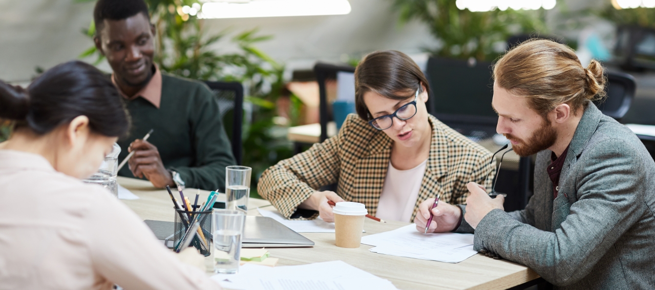 interns in an office working on a group project