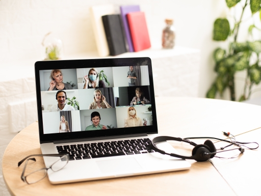 online class using laptop and headphones at office desk