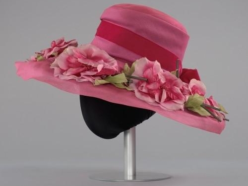 Pink hat adorned with pink flowers.